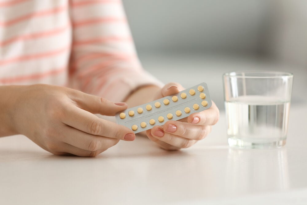 A woman learning how to use birth control pills A woman learning how to use birth control pills