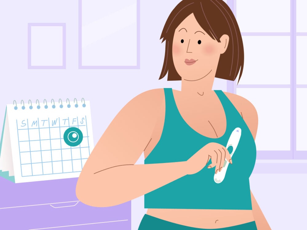 woman holding an ovulation test woman holding an ovulation test